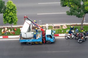 Overhead shot of workers with a truck and motorcycles on a city street.